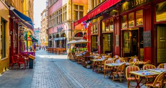 LYON, FRANCE, JULY 22, 2017: a narrow street full of restaurants is waiting for first customers to come, Lyon, France