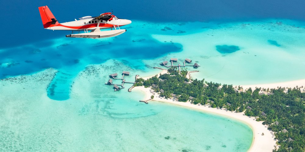Sea plane flying above Maldives islands, Raa atol