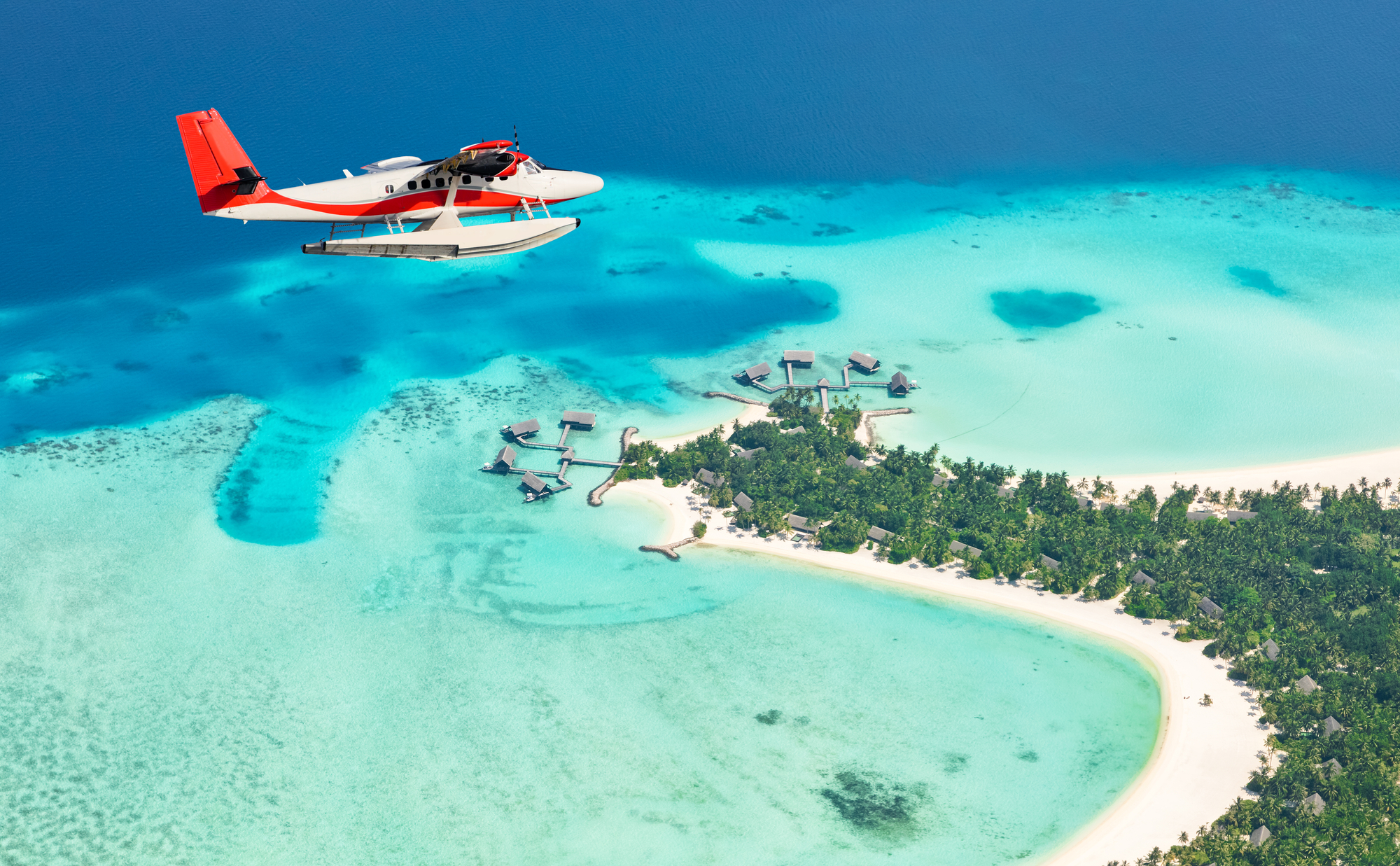 Sea plane flying above Maldives islands, Raa atol