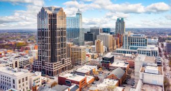 Aerial view of Raleigh, North Carolina skyline on a sunny day.