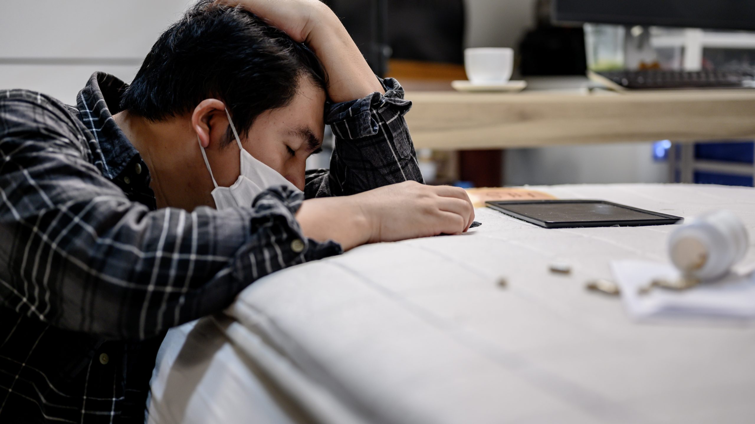 Businessman headache and take medicine. Unemployment and Mental health problem. Post-traumatic stress disorder (PTSD). Economic problems for workers in Asia.