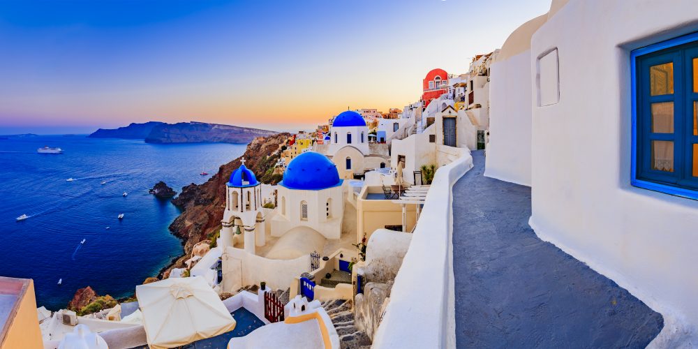 Amazing view with white houses in Oia village on Santorini island in Greece.