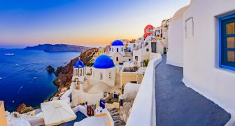 Amazing view with white houses in Oia village on Santorini island in Greece.