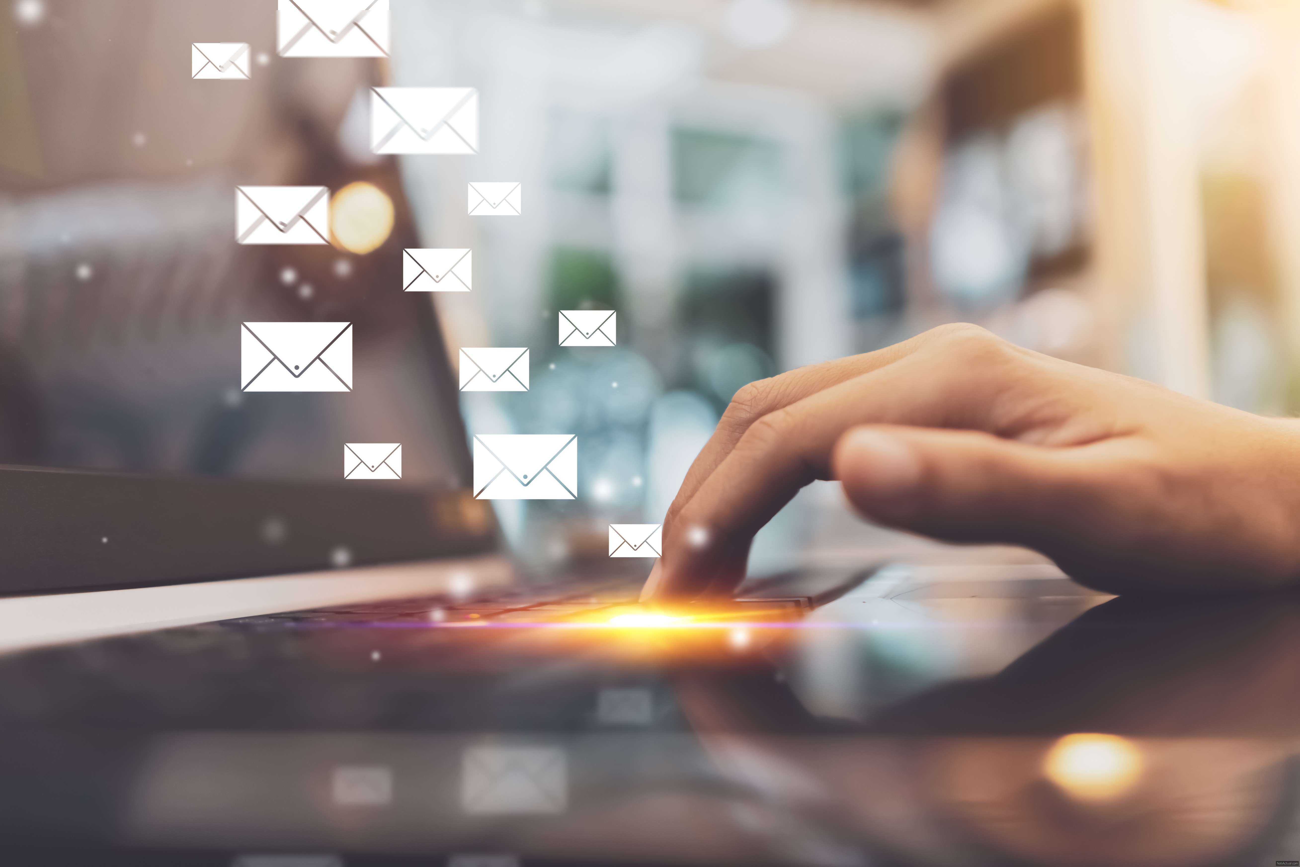 Close up woman hand using keyboard laptop with email icon flying and colorful bokeh light abstract background. Business economic technology and working connect concept. Vintage tone filter color.